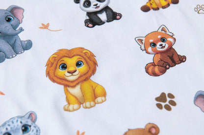 Detailed close-up of the premium jungle animal pyjama fabric showing soft cotton and colourful animal illustrations.