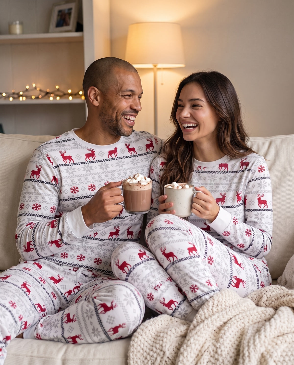 Couple relaxing on the sofa in their Christmas PJs