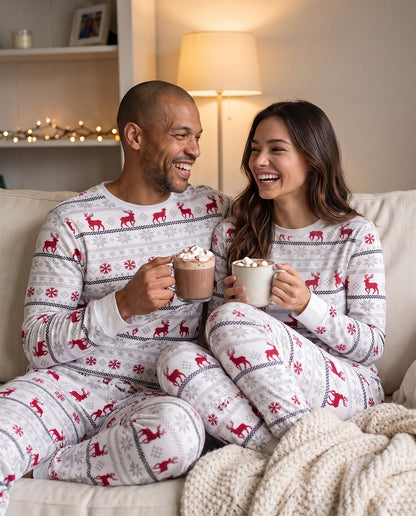 Couple relaxing on the sofa in their Christmas PJs