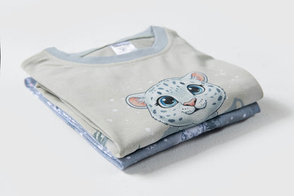 Folded blue snow leopard Christmas pyjamas showcasing premium cotton fabric and festive winter print.