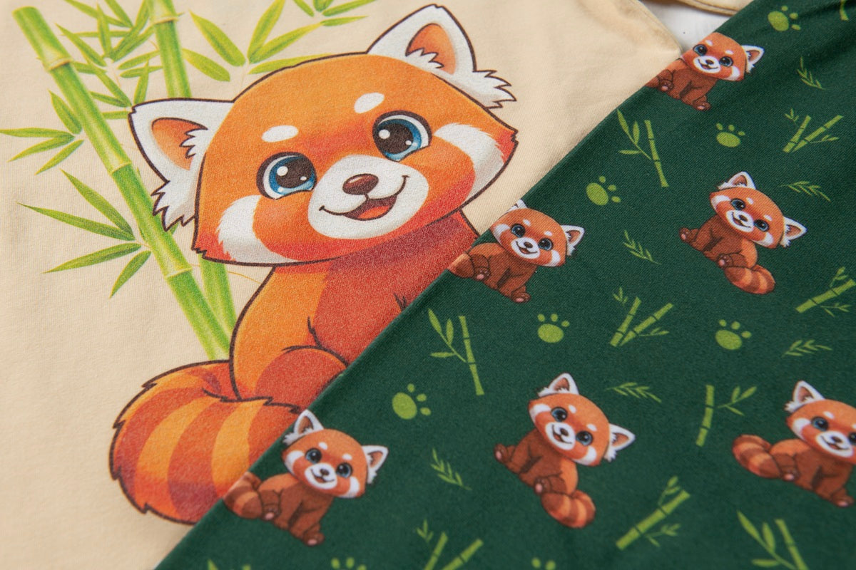 Close-up of Red Panda pyjama trousers featuring playful red panda and bamboo print