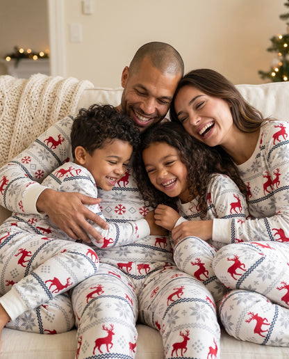 Family having Christmas fun on the sofa in their Nordic PJs